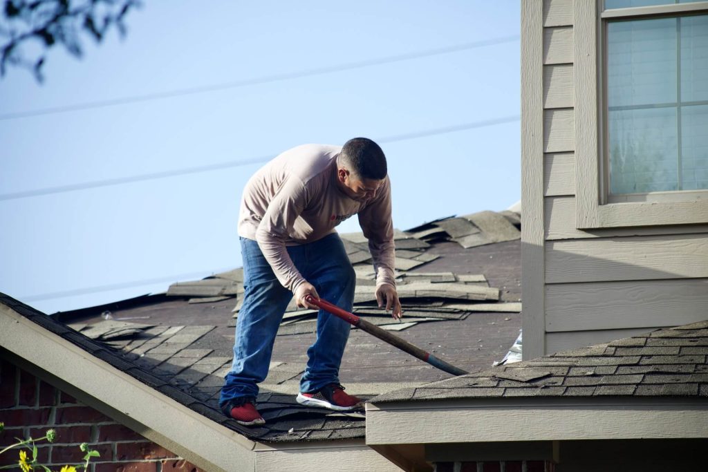unprofessional roofer without safety equipment